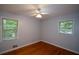 Cozy, light bedroom with hardwood floors, ceiling fan, and bright windows with views at 1376 Woodbine St, Marietta, GA 30062