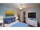 Comfortable bedroom features a ceiling fan, mounted television, and closet for ample storage at 1376 Woodbine St, Marietta, GA 30062