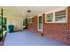 Spacious brick carport featuring a storage area, providing convenience and functionality at 1376 Woodbine St, Marietta, GA 30062