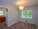 Charming dining area featuring an elegant chandelier, neutral walls, and large windows for light at 1376 Woodbine St, Marietta, GA 30062