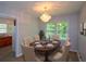 Elegant dining area with a chandelier, neutral walls, and large windows for natural light at 1376 Woodbine St, Marietta, GA 30062