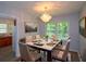 Charming dining area featuring an elegant chandelier, neutral walls, and large windows for light at 1376 Woodbine St, Marietta, GA 30062