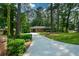 Charming brick home with a well-maintained yard and a long driveway surrounded by mature trees at 1376 Woodbine St, Marietta, GA 30062