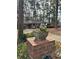 A classic brick home framed by lush greenery and mature trees with a charming walkway at 1376 Woodbine St, Marietta, GA 30062