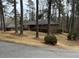 Charming brick home nestled among mature trees with a well-maintained front yard at 1376 Woodbine St, Marietta, GA 30062