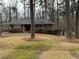 Traditional brick home with a neatly landscaped front yard, nestled among mature trees at 1376 Woodbine St, Marietta, GA 30062