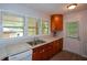 Functional kitchen with wooden cabinets, light countertops, and a stainless steel sink at 1376 Woodbine St, Marietta, GA 30062