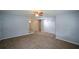 A view of a living room with carpet, natural paint, closet, and a large shelf unit at 1376 Woodbine St, Marietta, GA 30062