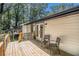 Inviting back deck with a wooden railing overlooking a lush backyard and outdoor seating at 2537 Baker Nw Rd, Atlanta, GA 30318