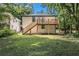 Exterior view of a home featuring a spacious deck, stairs, and decorative lattice panels in a lush, green backyard at 2537 Baker Nw Rd, Atlanta, GA 30318