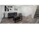 Cozy finished basement featuring vinyl plank flooring, gray sofa, and stylish artwork at 2537 Baker Nw Rd, Atlanta, GA 30318