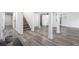 Bright basement with gray luxury vinyl plank, white walls, and staircase at 2537 Baker Nw Rd, Atlanta, GA 30318