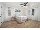 Bright bedroom with neutral tones, updated ceiling fan, and bright windows at 2537 Baker Nw Rd, Atlanta, GA 30318