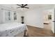 Bright bedroom with white trim, modern ceiling fan, and large sunny windows at 2537 Baker Nw Rd, Atlanta, GA 30318