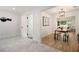Open concept dining area with hard surface flooring, a view to the living area, and a modern light fixture at 2537 Baker Nw Rd, Atlanta, GA 30318