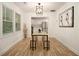Bright dining area with hardwood floors, a modern chandelier, and large windows next to a modern kitchen at 2537 Baker Nw Rd, Atlanta, GA 30318
