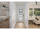 Bright entryway features a decorative glass door, opening to a bedroom and a living area with hardwood floors at 2537 Baker Nw Rd, Atlanta, GA 30318