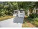 Attractive home with a long driveway and lush greenery, shaded by mature trees offering both curb appeal and privacy at 2537 Baker Nw Rd, Atlanta, GA 30318