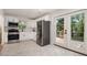 Modern kitchen features stainless steel appliances, white cabinetry, and access to a deck with a wooded view at 2537 Baker Nw Rd, Atlanta, GA 30318