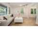 Bright living room with large windows, hardwood floors, modern decor, and track lighting for a sleek look at 2537 Baker Nw Rd, Atlanta, GA 30318