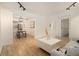 Spacious open-concept living area with hardwood floors, white walls, and modern furniture creating a stylish, airy feel at 2537 Baker Nw Rd, Atlanta, GA 30318