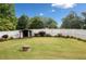 The backyard is lush and green, complete with a storage shed and sports net, all enclosed by a white privacy fence at 2545 Hickory Level Rd, Villa Rica, GA 30180