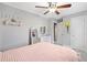 Bedroom featuring a bed, ceiling fan, mirror, and pink decor at 2545 Hickory Level Rd, Villa Rica, GA 30180