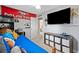 Bedroom with a blue bed, ceiling fan, and a television on the wall above storage cubes at 2545 Hickory Level Rd, Villa Rica, GA 30180