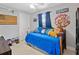 Bedroom with blue bedding, a ceiling fan, and decor items on the walls and surrounding area at 2545 Hickory Level Rd, Villa Rica, GA 30180