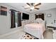 Light-filled bedroom with a white bed frame, ceiling fan and decor at 2545 Hickory Level Rd, Villa Rica, GA 30180