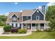 Charming two-story home with covered porch, manicured lawn and tasteful landscaping at 2545 Hickory Level Rd, Villa Rica, GA 30180