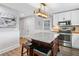 Kitchen with white cabinets, granite island with seating, and stainless steel appliances at 2545 Hickory Level Rd, Villa Rica, GA 30180