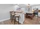Open kitchen design featuring white cabinets, stainless steel appliances and a granite kitchen island with seating at 2545 Hickory Level Rd, Villa Rica, GA 30180