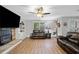 Comfortable living room with hardwood floors, ceiling fan, and a fireplace at 2545 Hickory Level Rd, Villa Rica, GA 30180