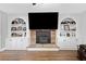Modern living room with wood floors, fireplace, and built in bookshelves at 2545 Hickory Level Rd, Villa Rica, GA 30180