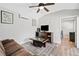 This cozy living room features light wood flooring, a television, stylish decor, and a ceiling fan at 2545 Hickory Level Rd, Villa Rica, GA 30180