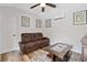 This cozy living room features light wood flooring, comfortable seating, stylish decor, and a ceiling fan at 2545 Hickory Level Rd, Villa Rica, GA 30180