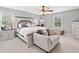 Comfortable main bedroom with light gray walls, carpet, a ceiling fan and two windows for natural light at 2545 Hickory Level Rd, Villa Rica, GA 30180