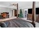Large main bedroom featuring a four-poster bed, desk, and television at 2545 Hickory Level Rd, Villa Rica, GA 30180