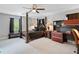 Spacious main bedroom with a four-poster bed, desk, and bench with natural lighting at 2545 Hickory Level Rd, Villa Rica, GA 30180