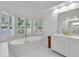 Luxurious bathroom with a soaking tub, marble floors, and a gold-framed vanity mirror at 3400 Dencrest Se Ct, Smyrna, GA 30080