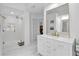 Bright bathroom showcasing a glass shower, marble floors and double vanity with gold hardware at 3400 Dencrest Se Ct, Smyrna, GA 30080