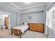 Comfortable bedroom with neutral walls and decor featuring a single bed, side table and bathroom at 3400 Dencrest Se Ct, Smyrna, GA 30080