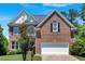 Charming two-story brick home featuring a well-manicured lawn and attached two-car garage at 3400 Dencrest Se Ct, Smyrna, GA 30080