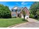Charming two-story brick home featuring a well-manicured lawn, two-car garage, and classic architectural details at 3400 Dencrest Se Ct, Smyrna, GA 30080