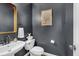 Elegant powder room featuring dark walls, a decorative mirror, and a modern sink at 3400 Dencrest Se Ct, Smyrna, GA 30080