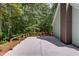 Spacious back deck with wood railing overlooking a private, wooded backyard at 5345 Pilgrim Point Rd, Cumming, GA 30041