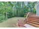 Spacious backyard with tiered deck offers a serene outdoor retreat amidst lush greenery at 5345 Pilgrim Point Rd, Cumming, GA 30041