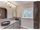 A modern bathroom features dual sinks, unique floors, and a decorative shower at 5345 Pilgrim Point Rd, Cumming, GA 30041