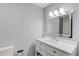 Bathroom with updated vanity, sink, updated lighting, and tiled accent wall at 5345 Pilgrim Point Rd, Cumming, GA 30041